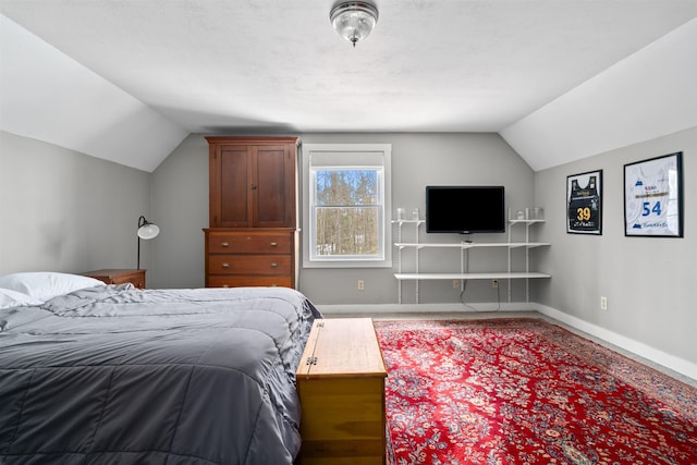 bedroom with vaulted ceiling and baseboards