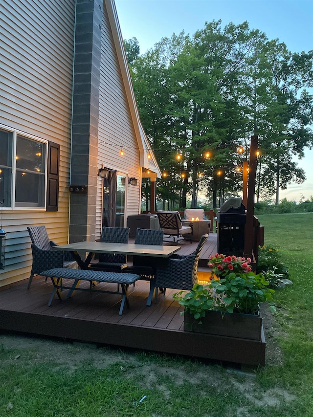 wooden terrace featuring a grill