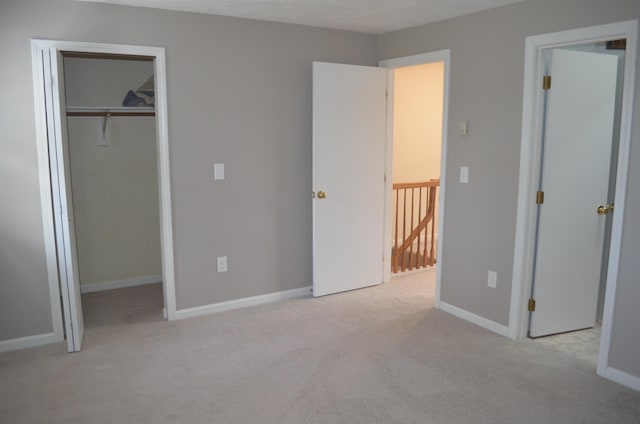 unfurnished bedroom featuring carpet, baseboards, and a closet