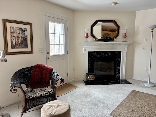 living area with baseboards, carpet floors, and a premium fireplace