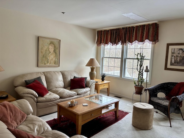 carpeted living area featuring visible vents and baseboards