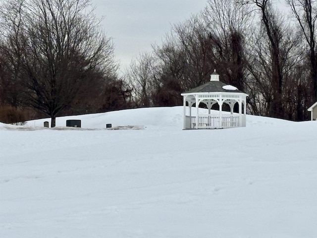 yard covered in snow with a gazebo