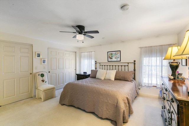 carpeted bedroom featuring a closet and ceiling fan