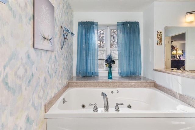 full bath with wallpapered walls and a whirlpool tub