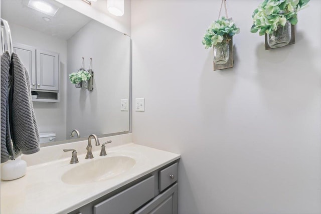 bathroom featuring toilet and vanity