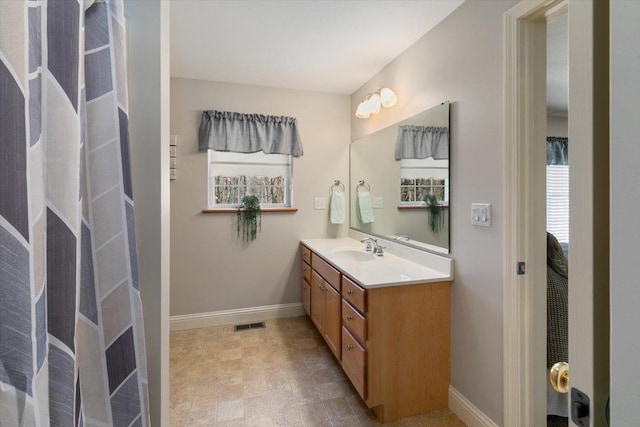 bathroom with visible vents, baseboards, and vanity