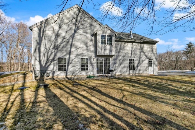 rear view of property with a lawn