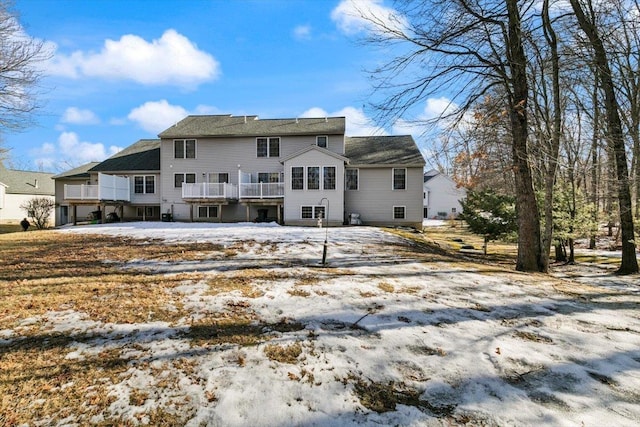 snow covered house with a deck