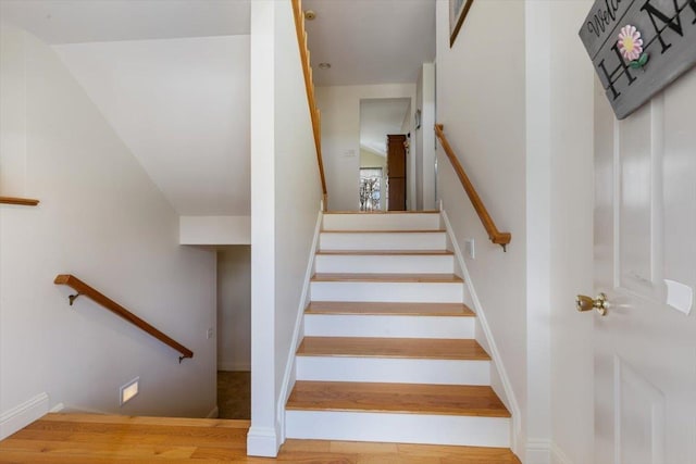 stairs featuring baseboards and wood finished floors