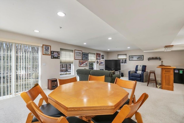 dining space featuring recessed lighting and light colored carpet