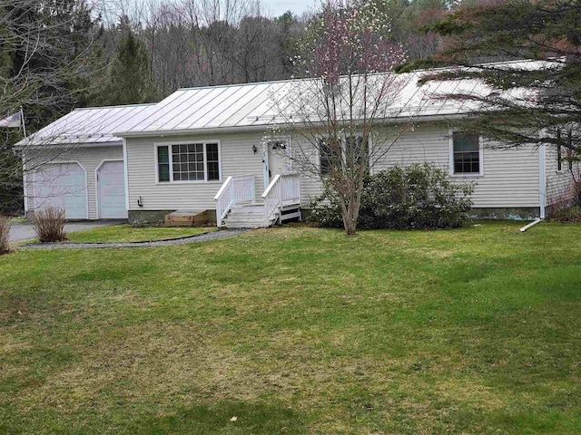 single story home with driveway, a standing seam roof, metal roof, a front yard, and a garage