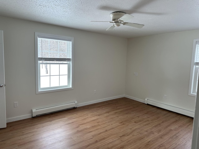 unfurnished room featuring a textured ceiling, wood finished floors, a ceiling fan, and a baseboard radiator