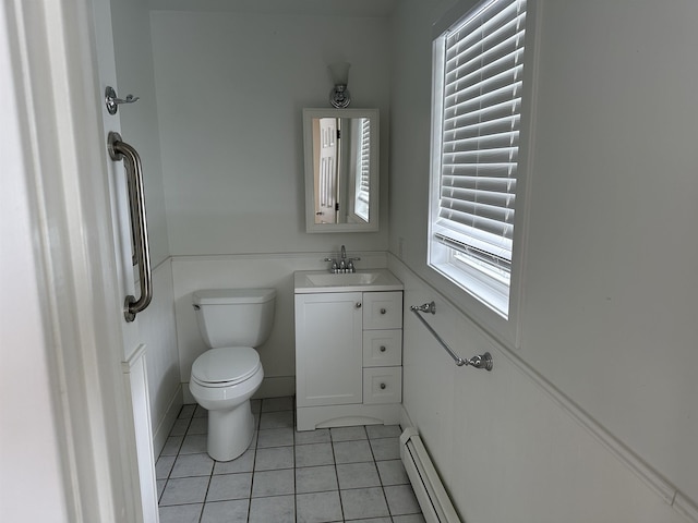 half bath featuring tile patterned floors, toilet, vanity, and a baseboard radiator