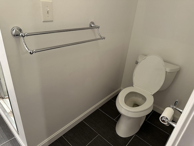 bathroom featuring toilet and baseboards