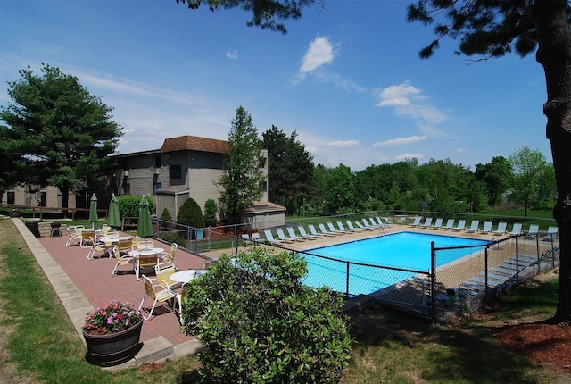 community pool featuring a patio area and fence