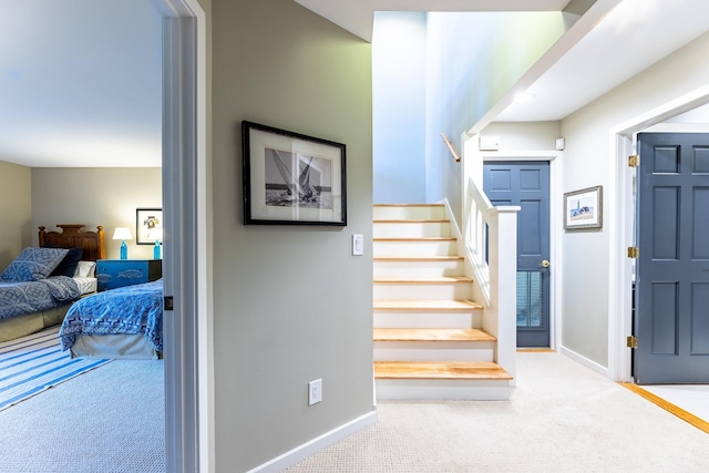 staircase with carpet flooring and baseboards