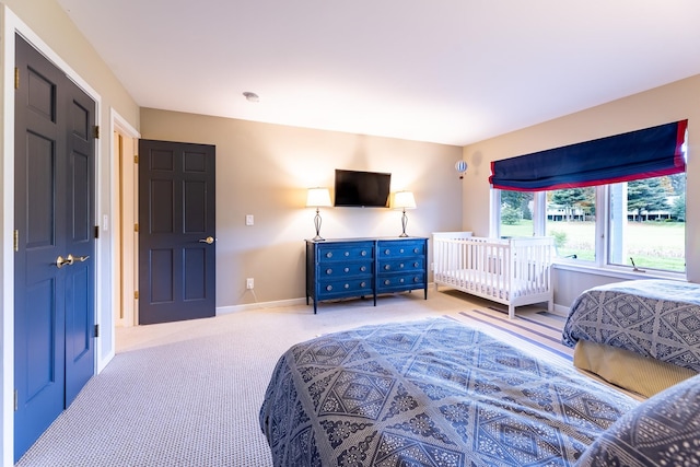 carpeted bedroom featuring baseboards