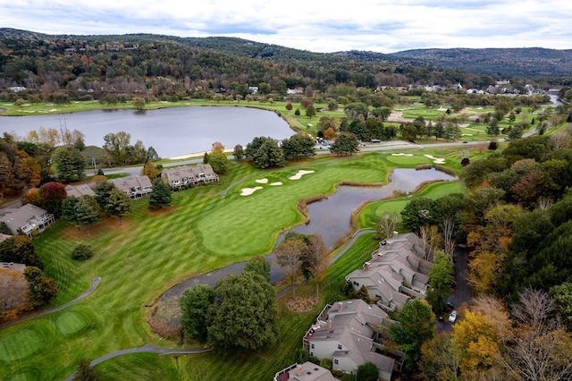 bird's eye view featuring a water view, a wooded view, and golf course view