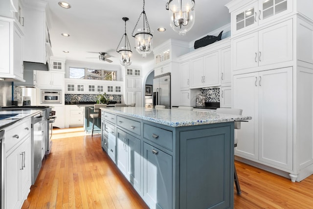 kitchen featuring white cabinetry, a kitchen island, and stainless steel appliances