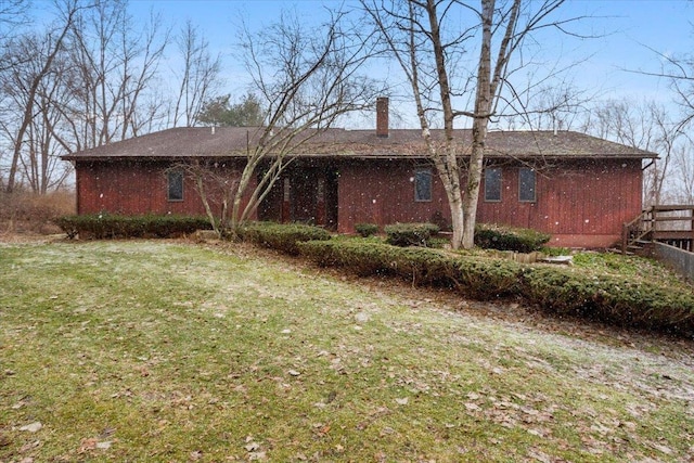 back of property featuring a yard and a chimney