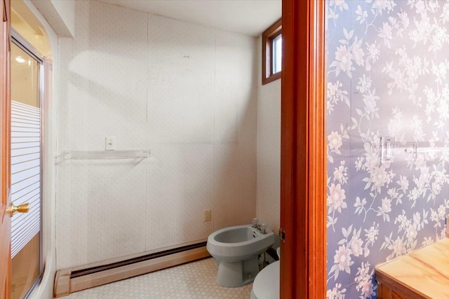 full bathroom featuring baseboard heating, a stall shower, toilet, and a bidet