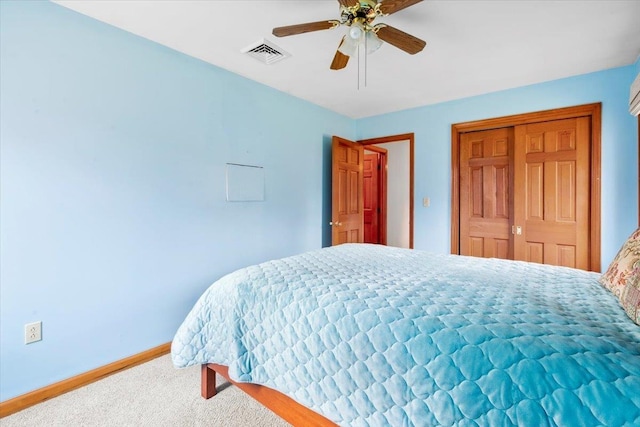 carpeted bedroom with visible vents, baseboards, a closet, and ceiling fan