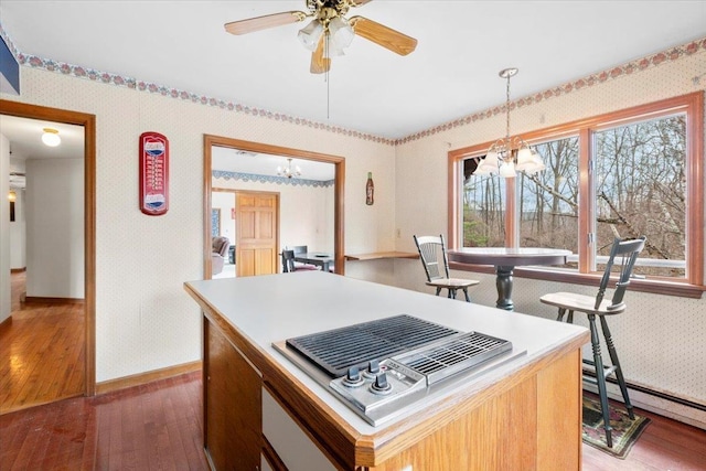 kitchen featuring stovetop with downdraft, light wood-style flooring, wallpapered walls, and a baseboard radiator