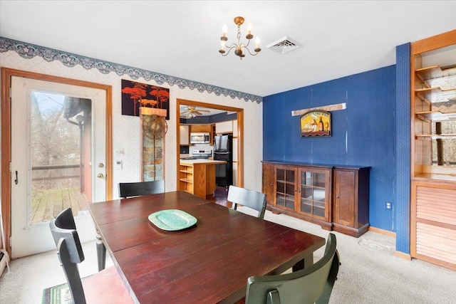 dining room featuring visible vents, wallpapered walls, baseboards, light colored carpet, and an inviting chandelier