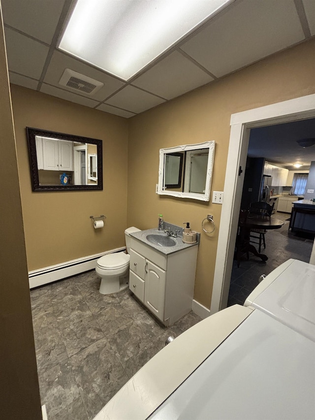 bathroom with vanity, visible vents, a baseboard radiator, a paneled ceiling, and toilet