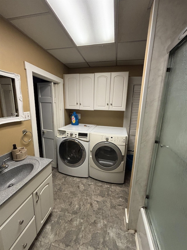 laundry area featuring washing machine and dryer and a sink