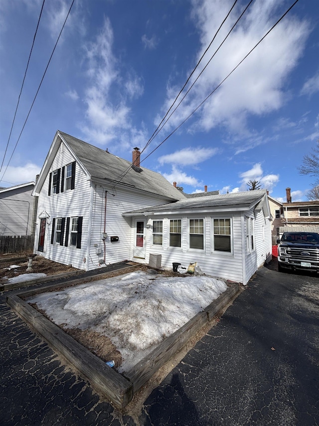 view of front of house featuring a chimney