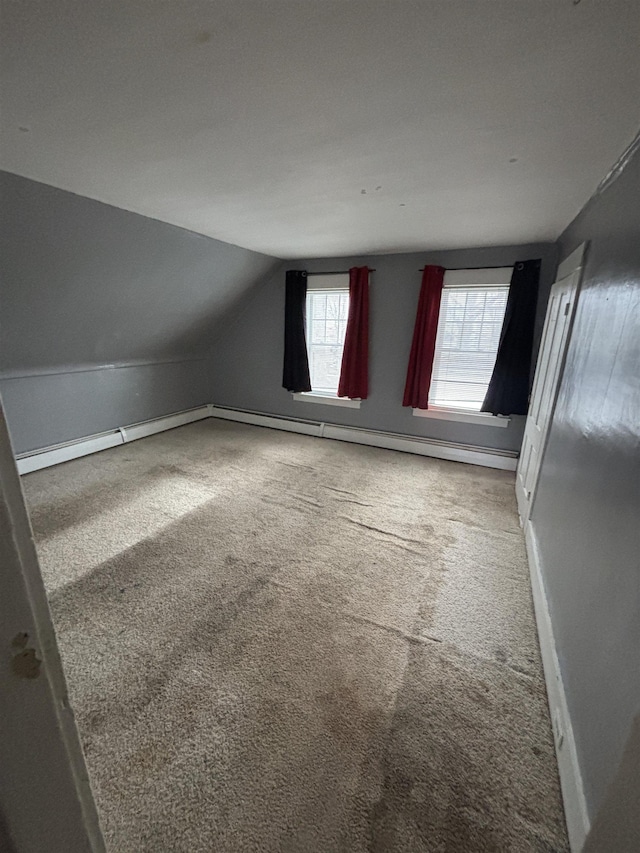 bonus room with baseboard heating, baseboards, lofted ceiling, and carpet