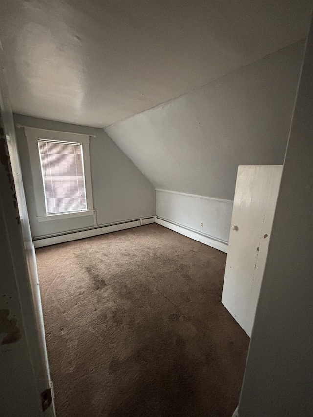 bonus room with vaulted ceiling and carpet flooring