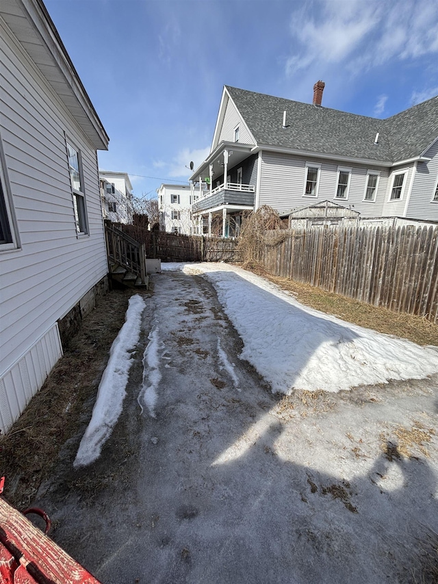 view of yard with driveway and fence