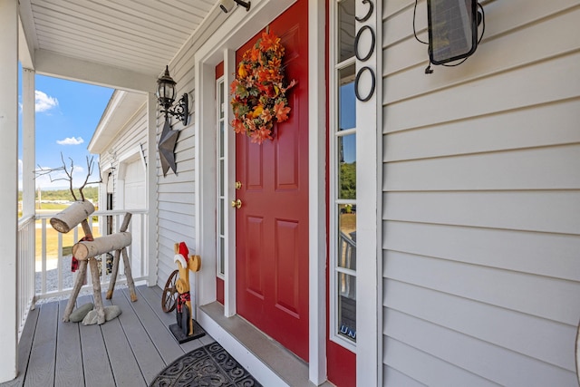 view of exterior entry with a porch