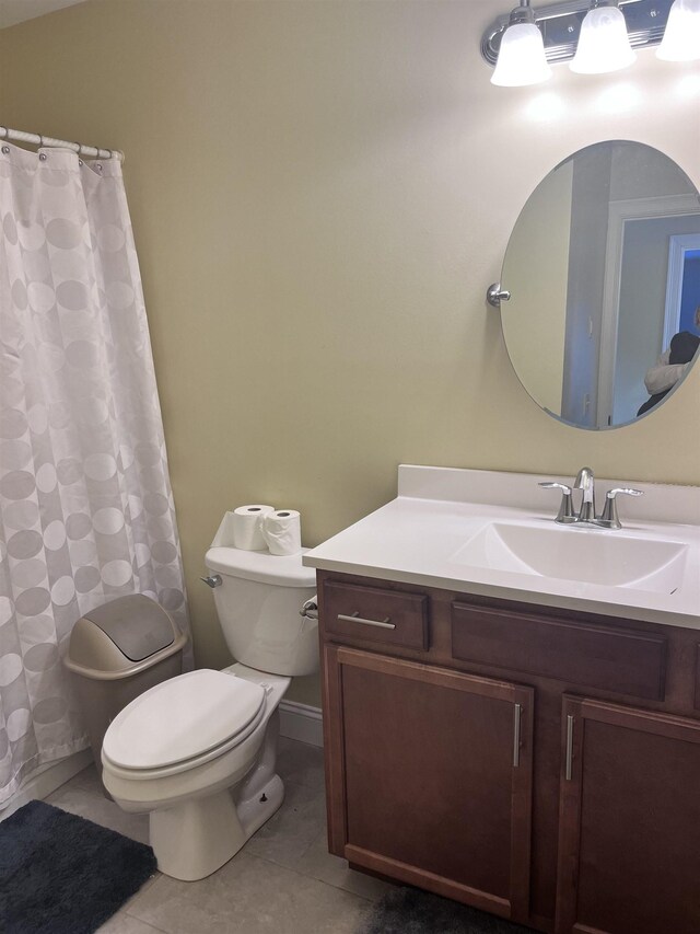 bathroom featuring tile patterned floors, a shower with curtain, toilet, and vanity