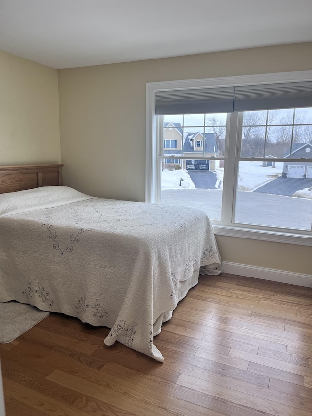 unfurnished bedroom featuring baseboards and wood finished floors