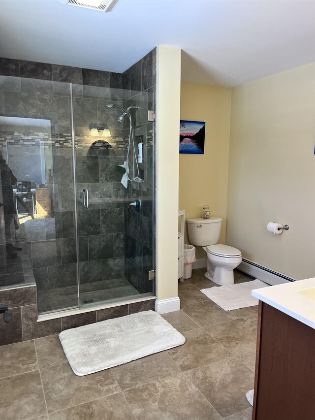 full bath with vanity, baseboards, a shower stall, a baseboard heating unit, and toilet