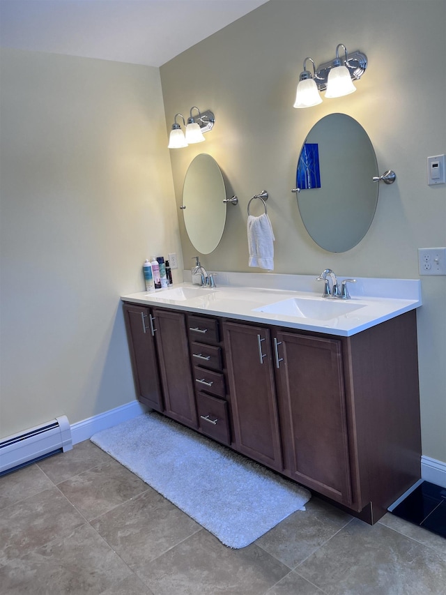 full bathroom featuring a baseboard heating unit, double vanity, baseboards, and a sink