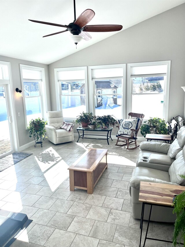 living room with a ceiling fan and vaulted ceiling