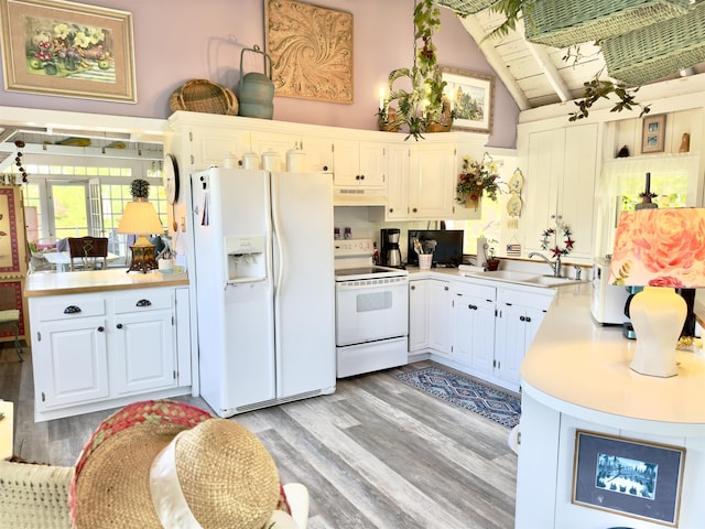 kitchen featuring a sink, white appliances, light wood-style floors, and light countertops