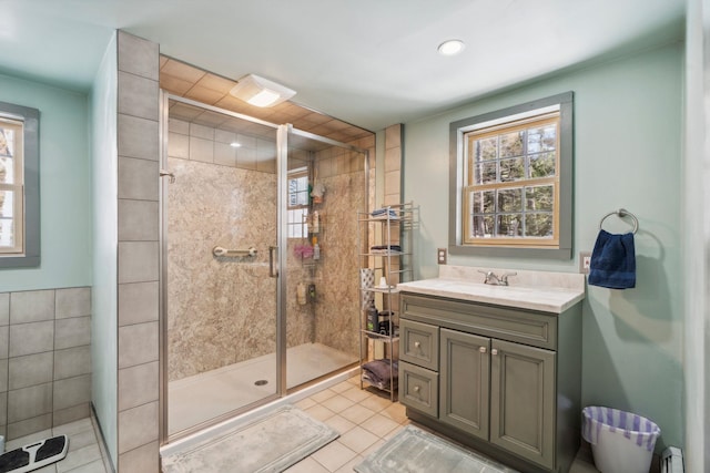 bathroom featuring a shower stall, plenty of natural light, and tile patterned floors