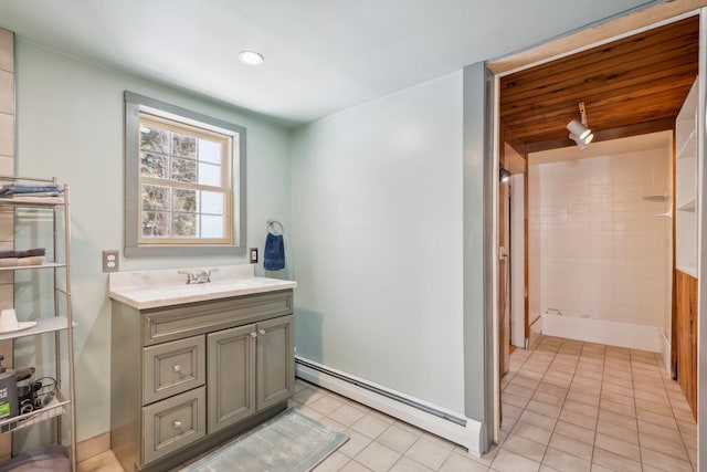 full bath featuring tile patterned floors, a baseboard radiator, a shower, and vanity