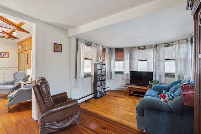 living room featuring baseboard heating and wood-type flooring