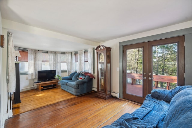 living area with hardwood / wood-style floors, french doors, and a baseboard radiator