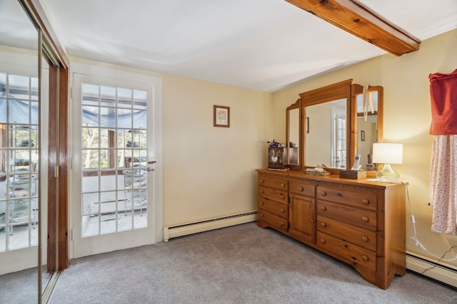 carpeted bedroom with a baseboard radiator and beamed ceiling