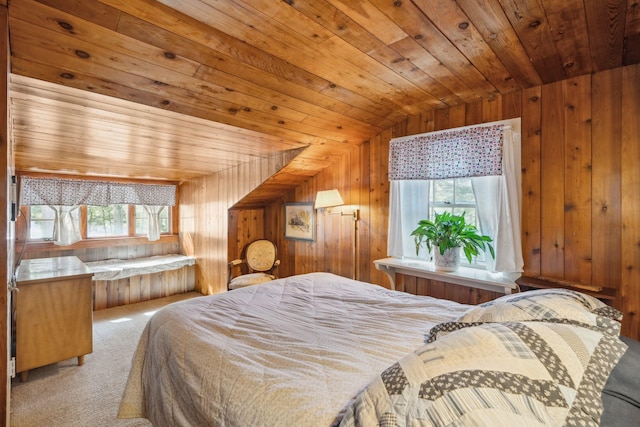 carpeted bedroom with wooden walls, multiple windows, wood ceiling, and vaulted ceiling