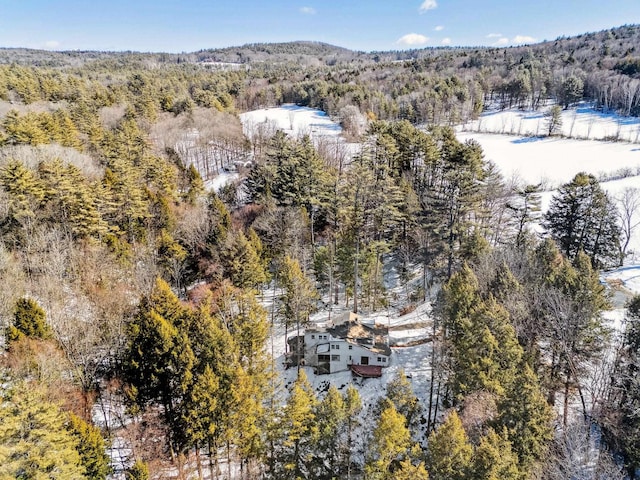 birds eye view of property featuring a wooded view