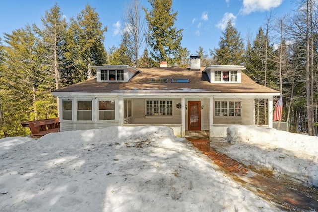 view of front of home featuring a porch and a chimney