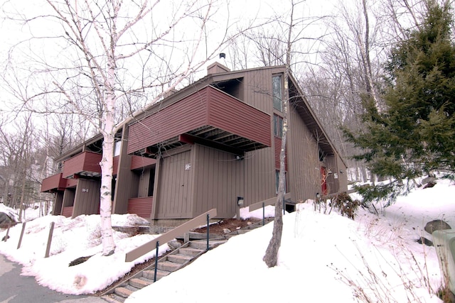 view of front of property featuring a chimney and a garage